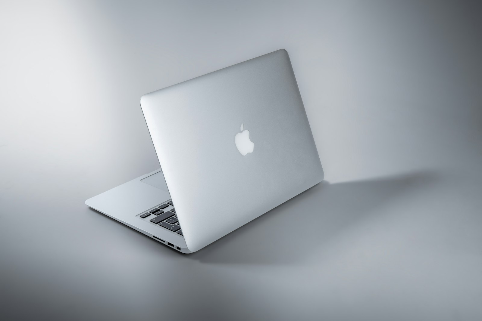 Closed silver MacBook Air on a gradient studio backdrop