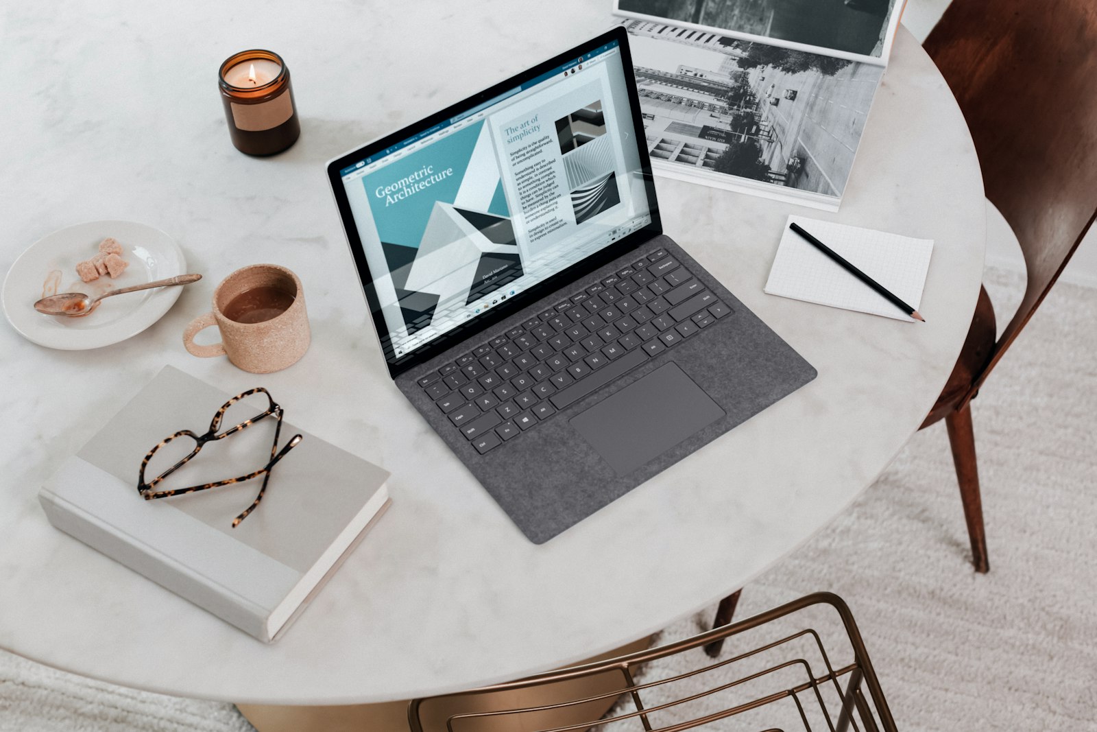 Person typing on a laptop at a wooden desk