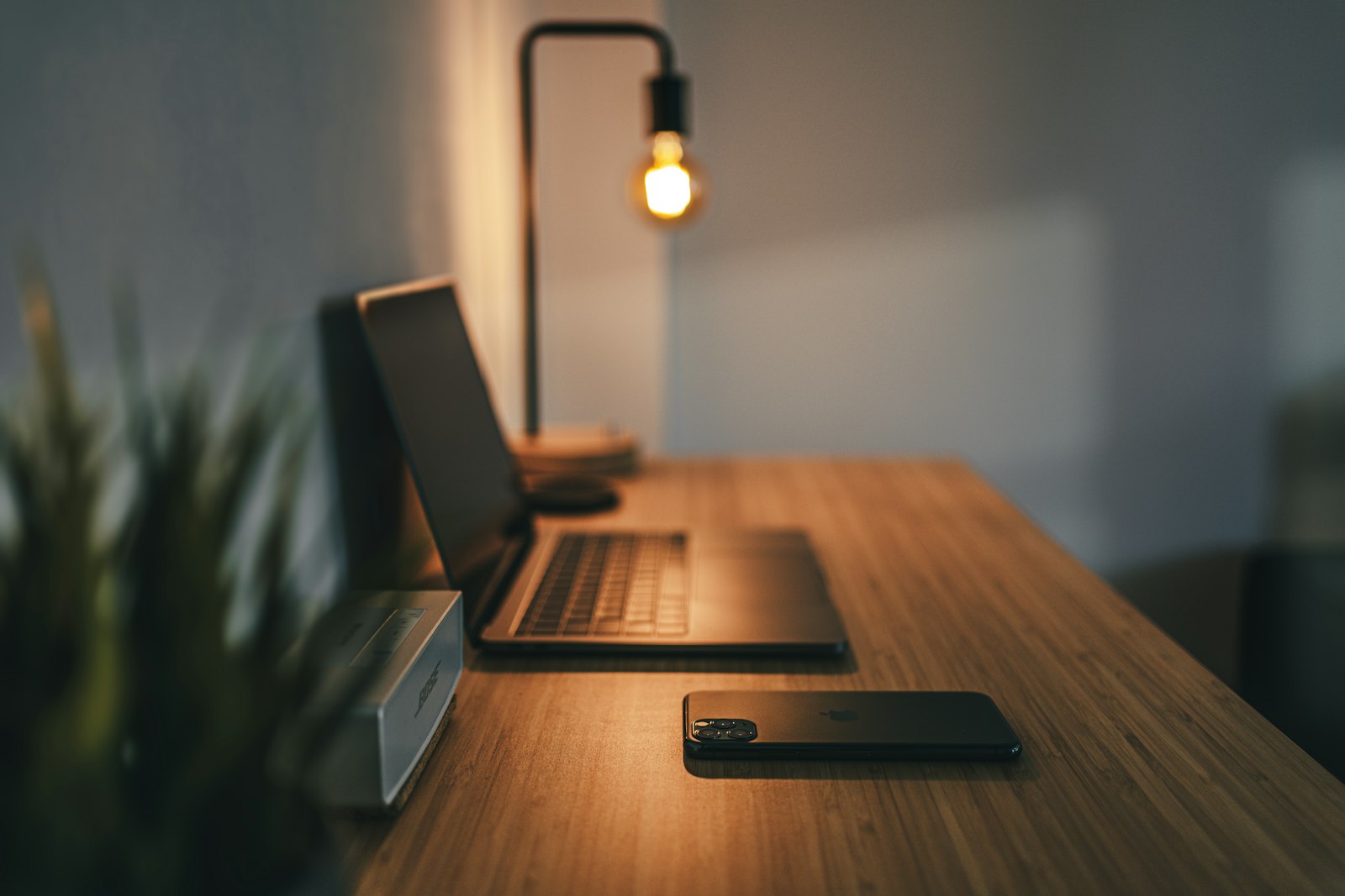 Open laptop on a desk with notebooks and daylight